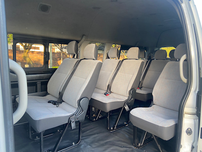 Spacious and clean interior of a Toyota Quantum shuttle, featuring comfortable seating, air conditioning, and a modern design for a smooth ride.