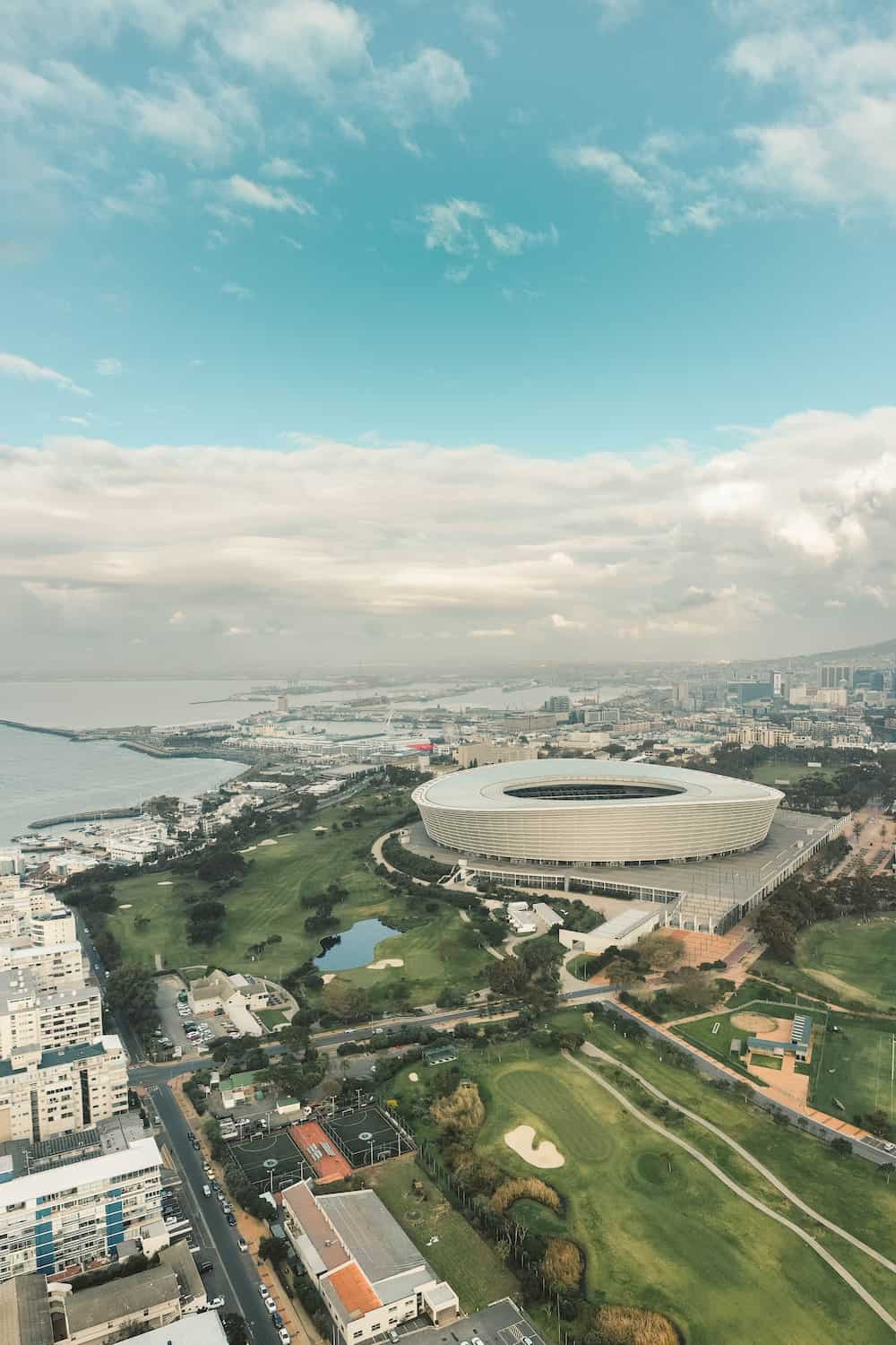 Cape Town’s DHL Stadium with the ocean stretching beyond Sea Point, showcasing the city's vibrant energy and stunning coastal views.